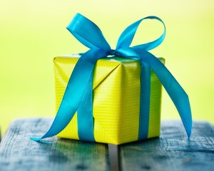 gift box on wooden table on natural sunny background